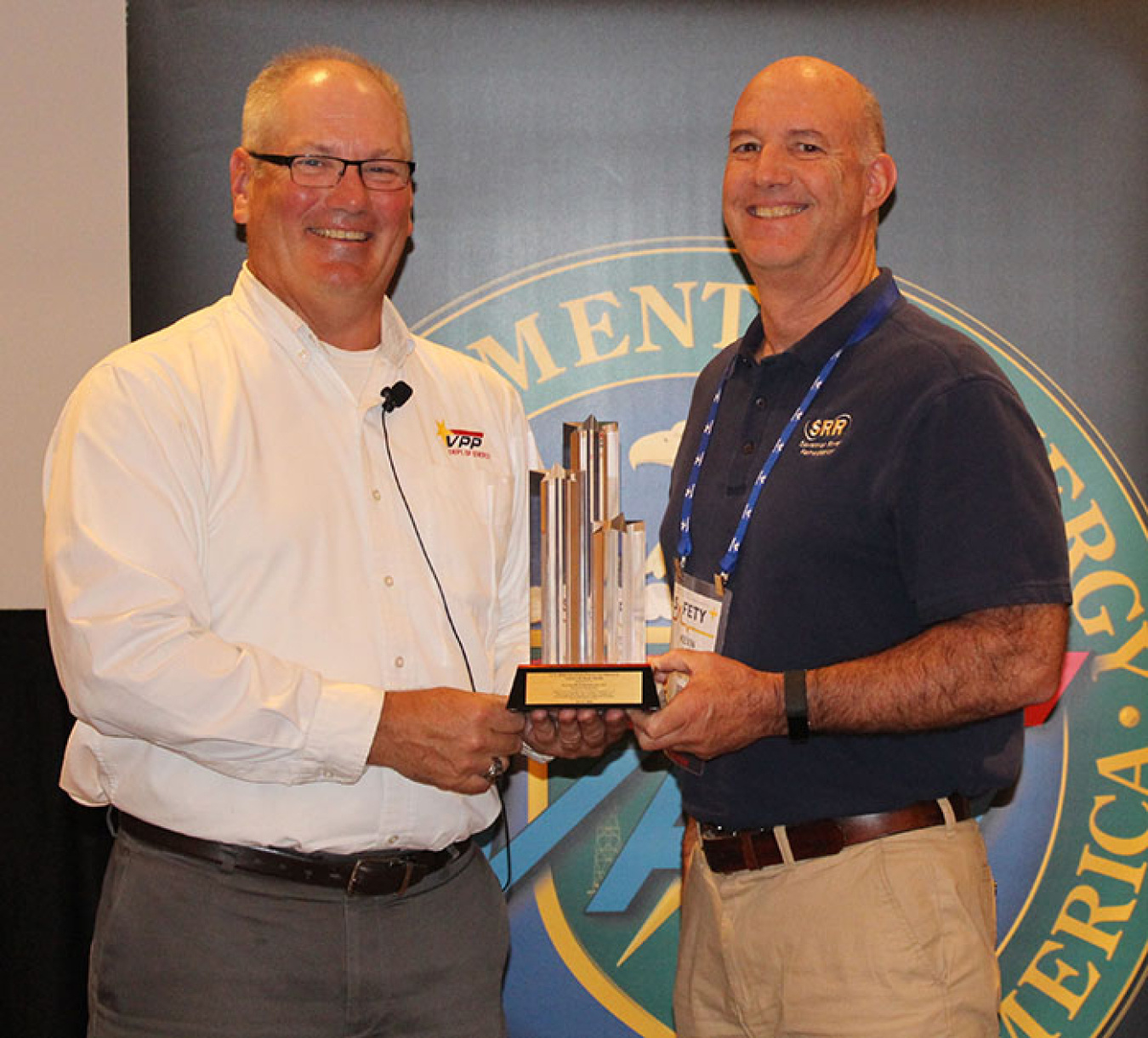 Savannah River Remediation Environmental, Safety, and Health Programs Manager Kevin Smith, right, accepts the Voluntary Protection Program Legacy of Stars Award from DOE Office of Worker Safety and Health Assistance Director Brad Davy.
