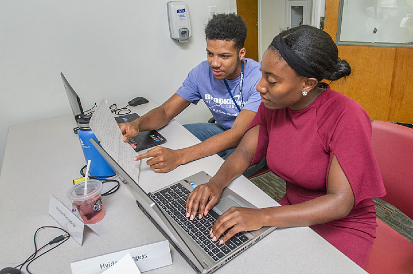 Mustafa Shabazz of the University of Pennsylvania (left) and Hyidea Burgess of Alabama A&M University develop software that can quickly balance complex oxidation-reduction chemical reactions.