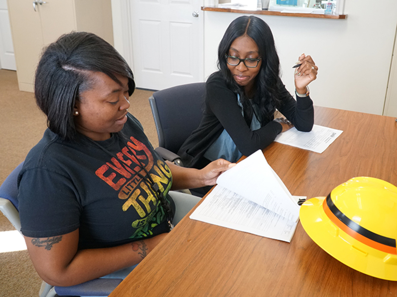 Savannah River Remediation (SRR) labor relations summer intern Mikhaela Kelson (right) oversaw the onboarding paperwork process with newly hired SRR Construction Laborer Sherlaine Flournoy.