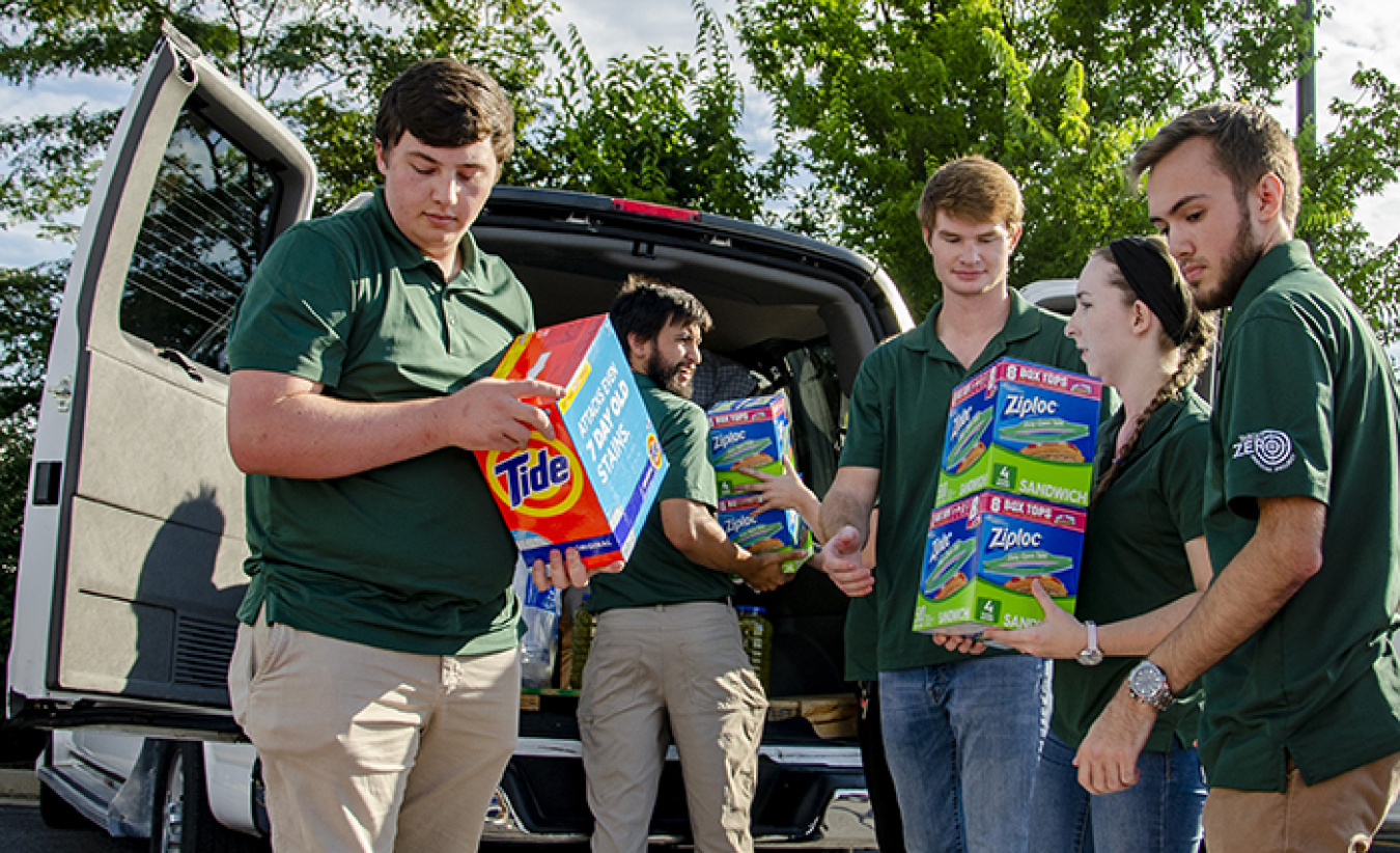 Supporting a Paducah Site community service outreach, college interns load supplies donated by the annual Feds Feed Families food drive for a western Kentucky charity.
