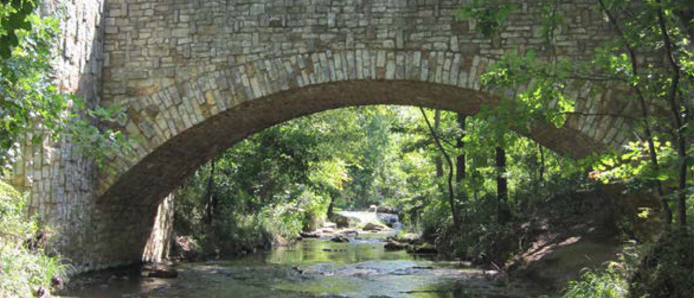 A stone bridge over a creek.