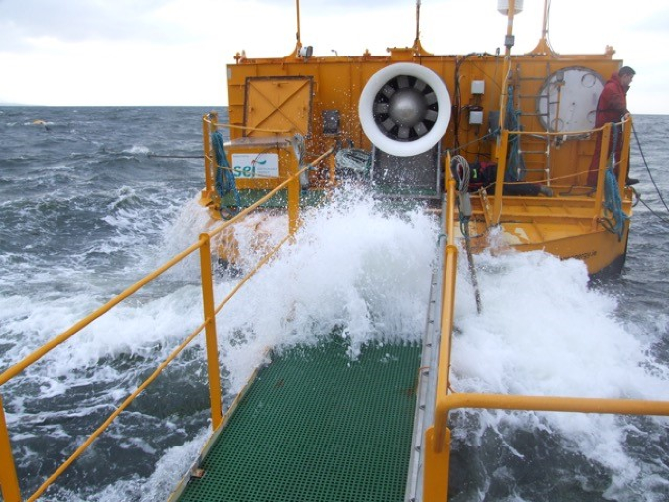 Photo of a platform leading to a buoy in rough seas.