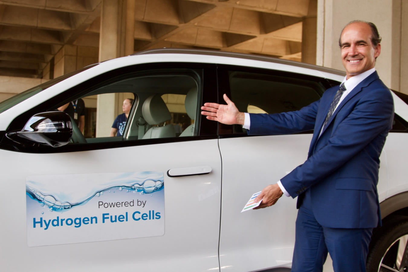 Under Secretary of Energy Mark Menezes in front of a fuel cell electric car 