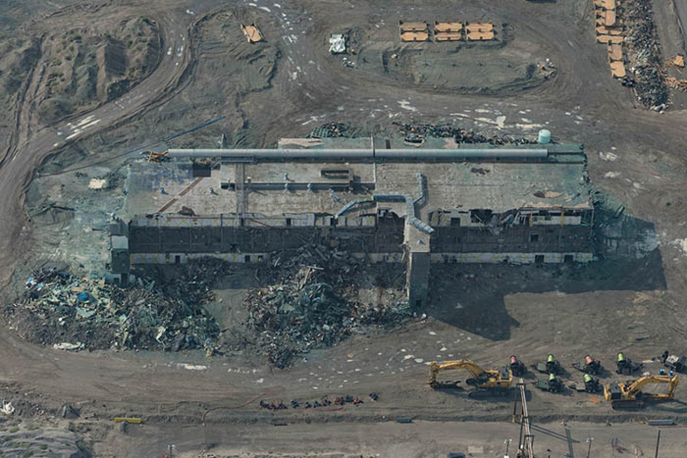 Workers have resumed lower-risk demolition-related activities at the Plutonium Finishing Plant. Their first task is loading out demolition debris already on the ground, pictured in this August 2018 aerial image. 