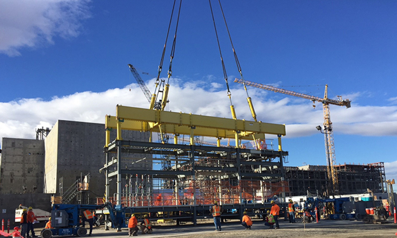 A 40-ton process cell pipe rack is moved into the Effluent Management Facility using a heavy lift crane.