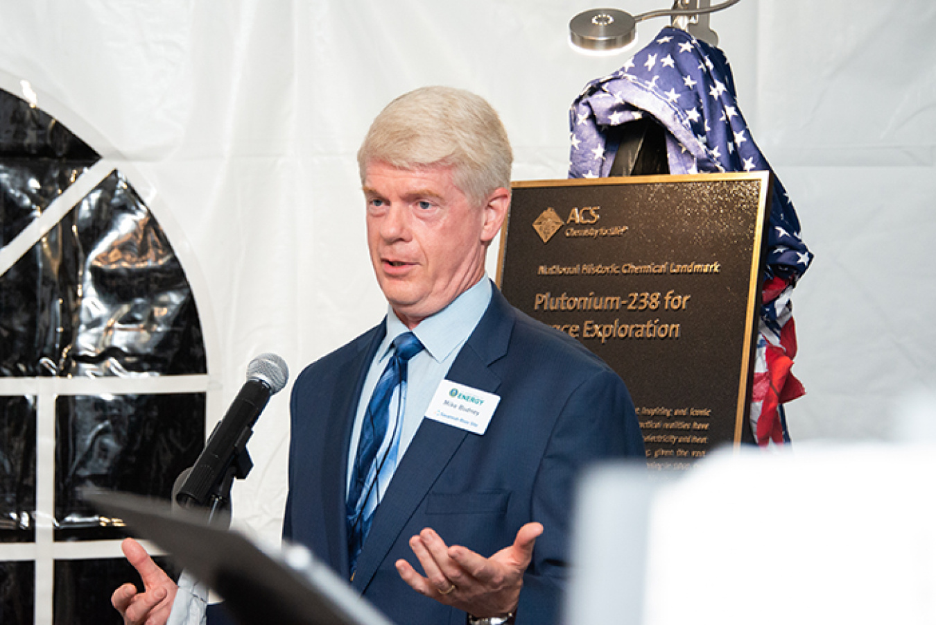Mike Budney, manager of DOE’s Savannah River Site Operations Office, accepts a commemorative plaque recognizing the Savannah River Site’s role in the production, separation, and supply of plutonium-238.