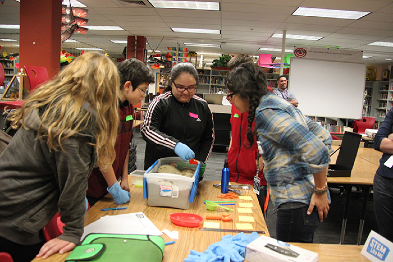 Middle school students use scientific methods to characterize items in soil during a STEM Like Me! session with Hanford Site workers.