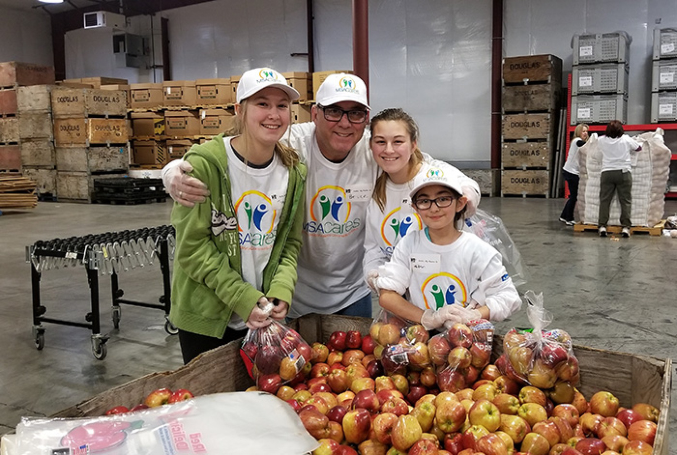 Bruce Pritchard with EM Richland Operations Office contractor Mission Support Alliance brought his three granddaughters, from left, Trista, Sloan, and Haiden, to volunteer at Second Harvest.