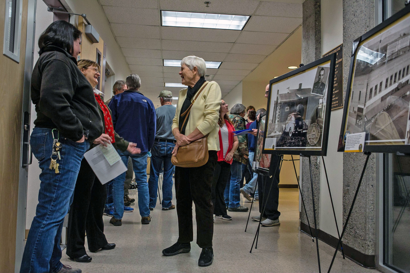 Attendees discuss the historic photo display.