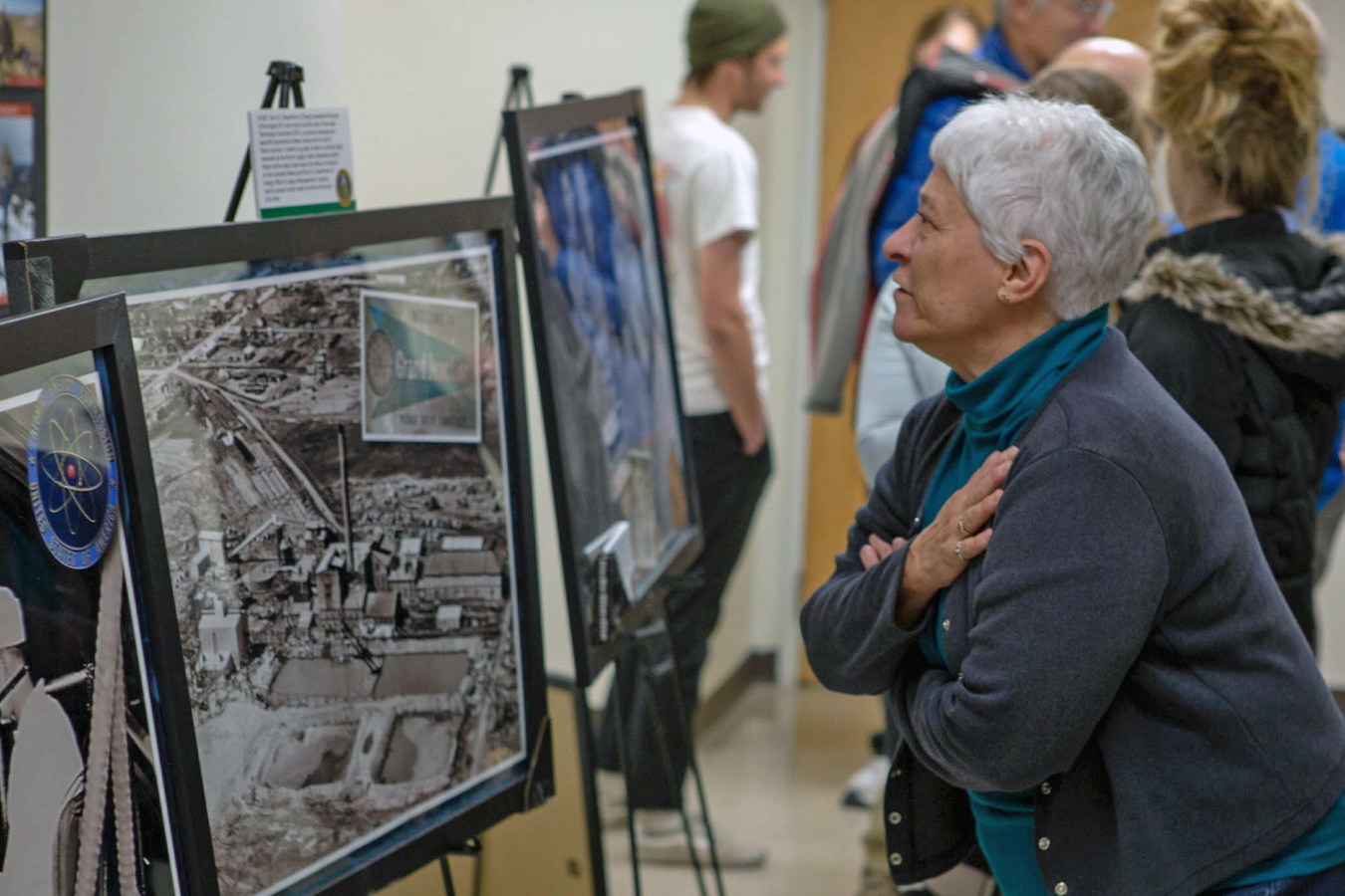 Attendee looks at a photo of the Climax Uranium Company Mill.