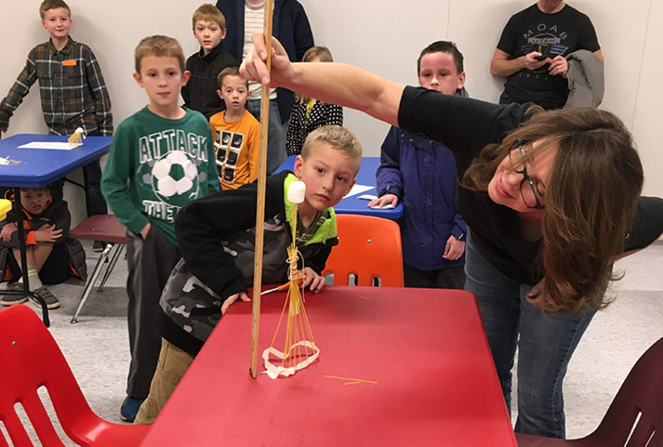 American Museum of Science and Energy Science Educator Kathleen Lyon measures structure heights in the “marshmallow challenge.”