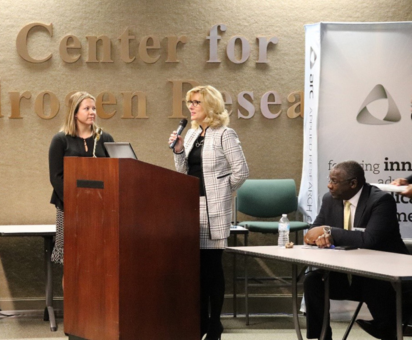Sandra Fairchild speaks at the forum as SRR Small Business Program Manager Elizabeth Wooten and Johnson listen.