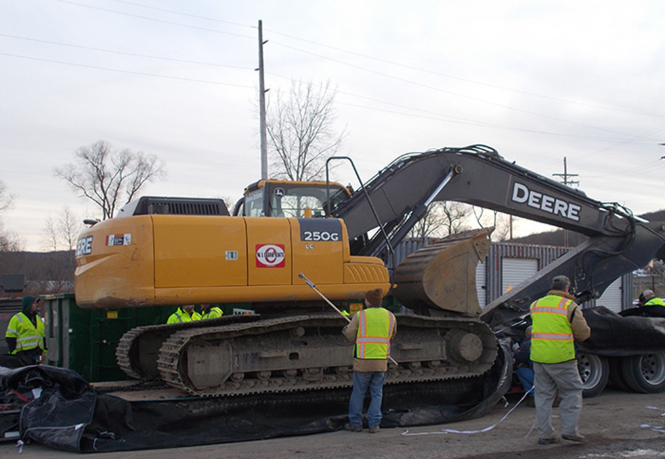 Workers inspect an excavator after it arrived at the West Valley Demonstration Project from the Separations Process Research Unit. 