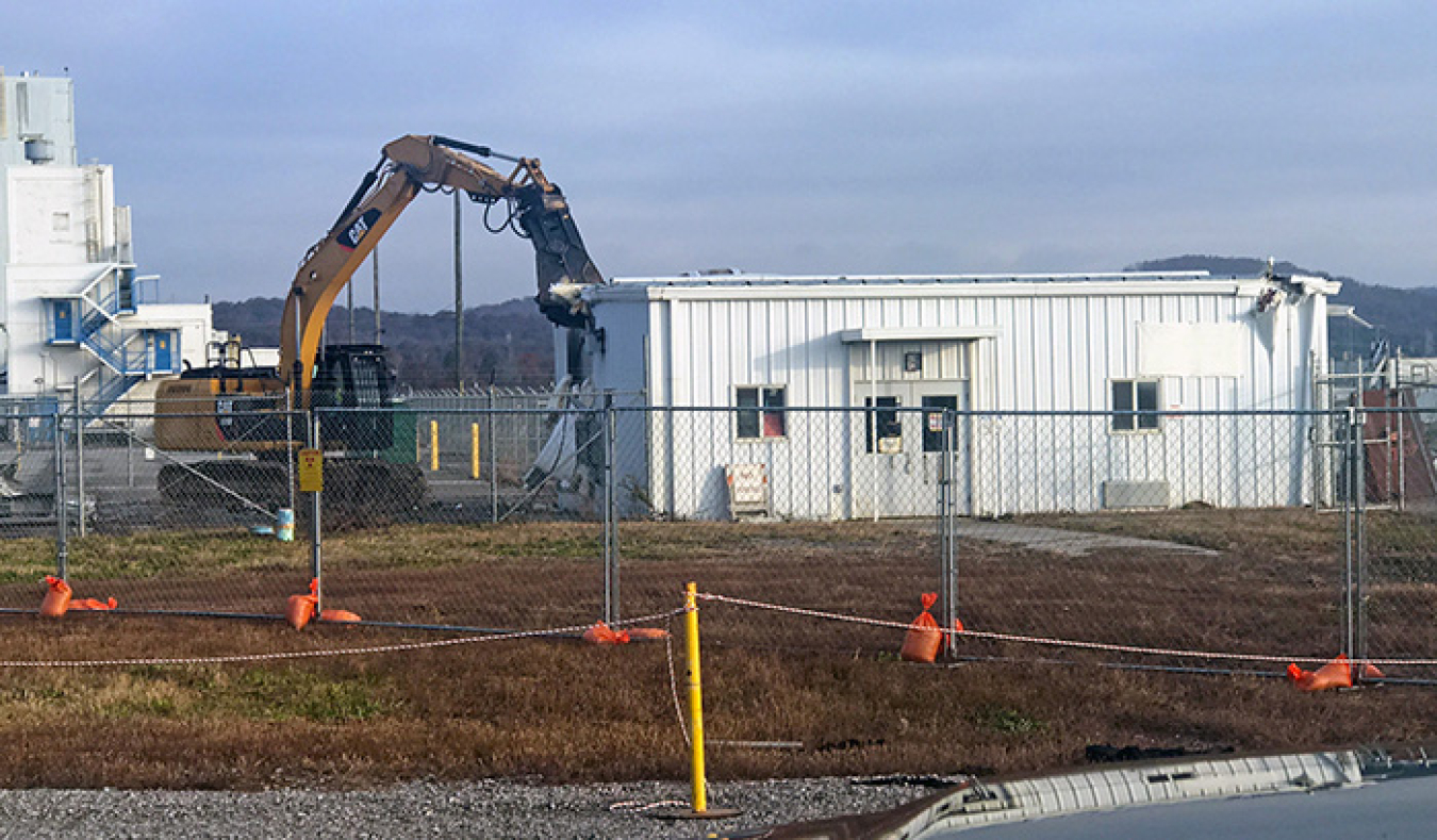 Workers demolish one of the portals that controlled access to the K-25 Building.