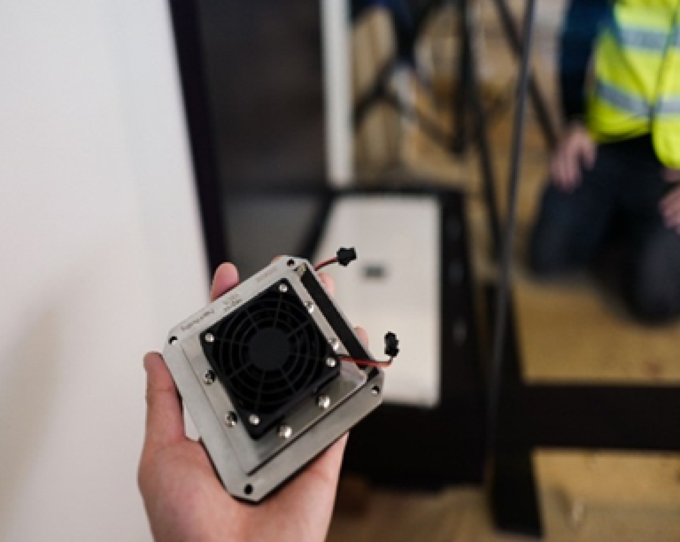 Hand holding the electrochemical humidity control device prior to installation at the Statue of Liberty Museum.