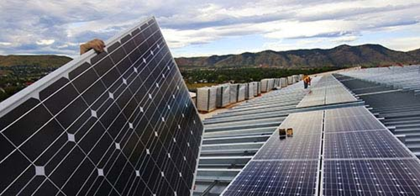 Solar panels with the mountains in the background.
