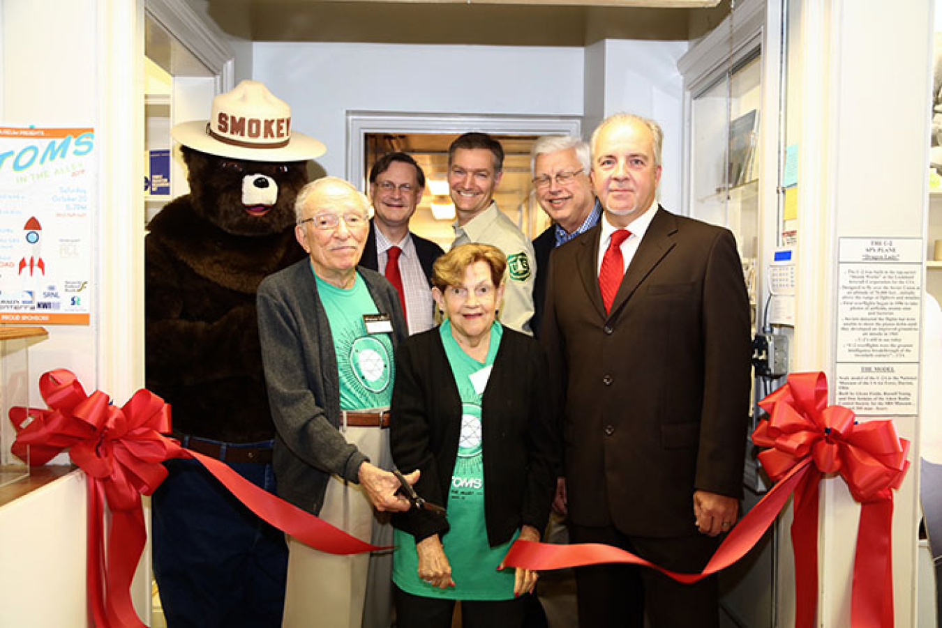 Officials gather for a ribbon cutting ceremony to open an environmental stewardship gallery at the SRS Museum. 
