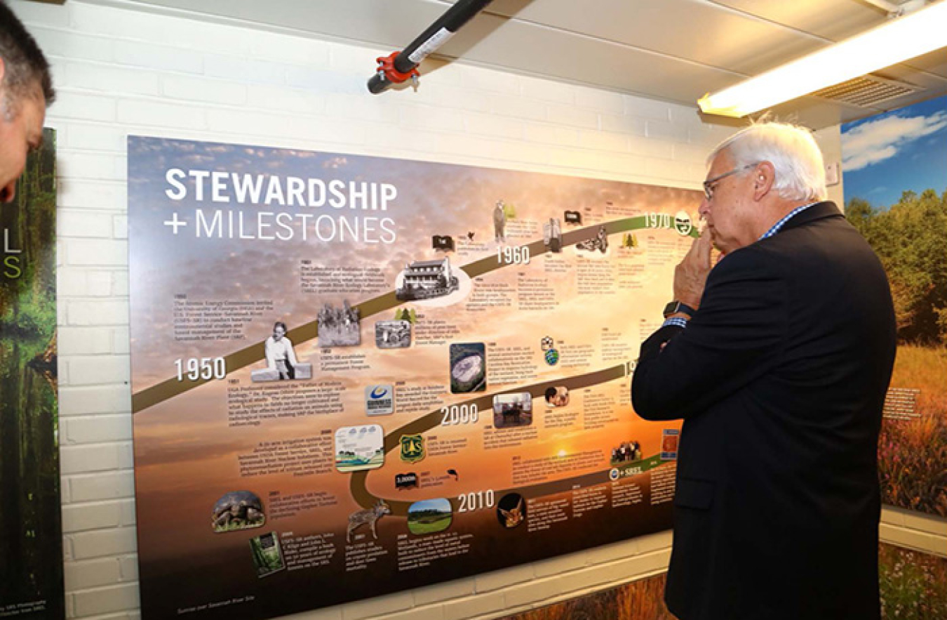David Jameson, president and CEO of the Aiken Chamber of Commerce, studies the historical timeline of Savannah River Site accomplishments.