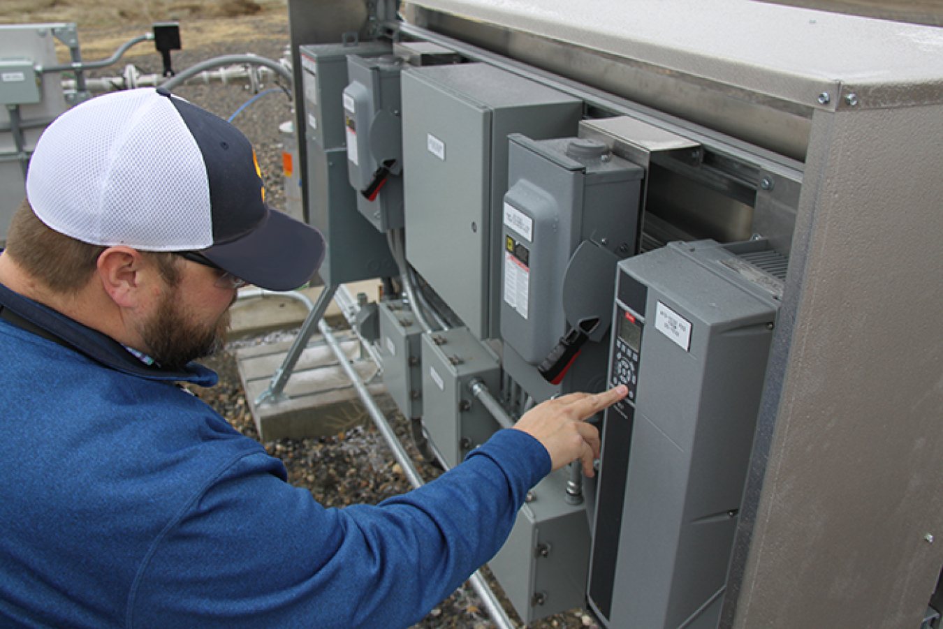 Buddy Cunningham, a construction project manager with CH2M HILL Plateau Remediation Company, checks equipment at the Hanford Site’s recently expanded groundwater extraction system.