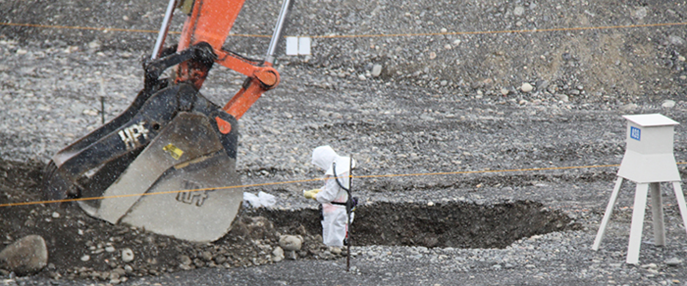 A worker with CH2M HILL Plateau Remediation Company checks for radioactive contamination during remediation of a small radioactive waste site near the former K East Reactor.