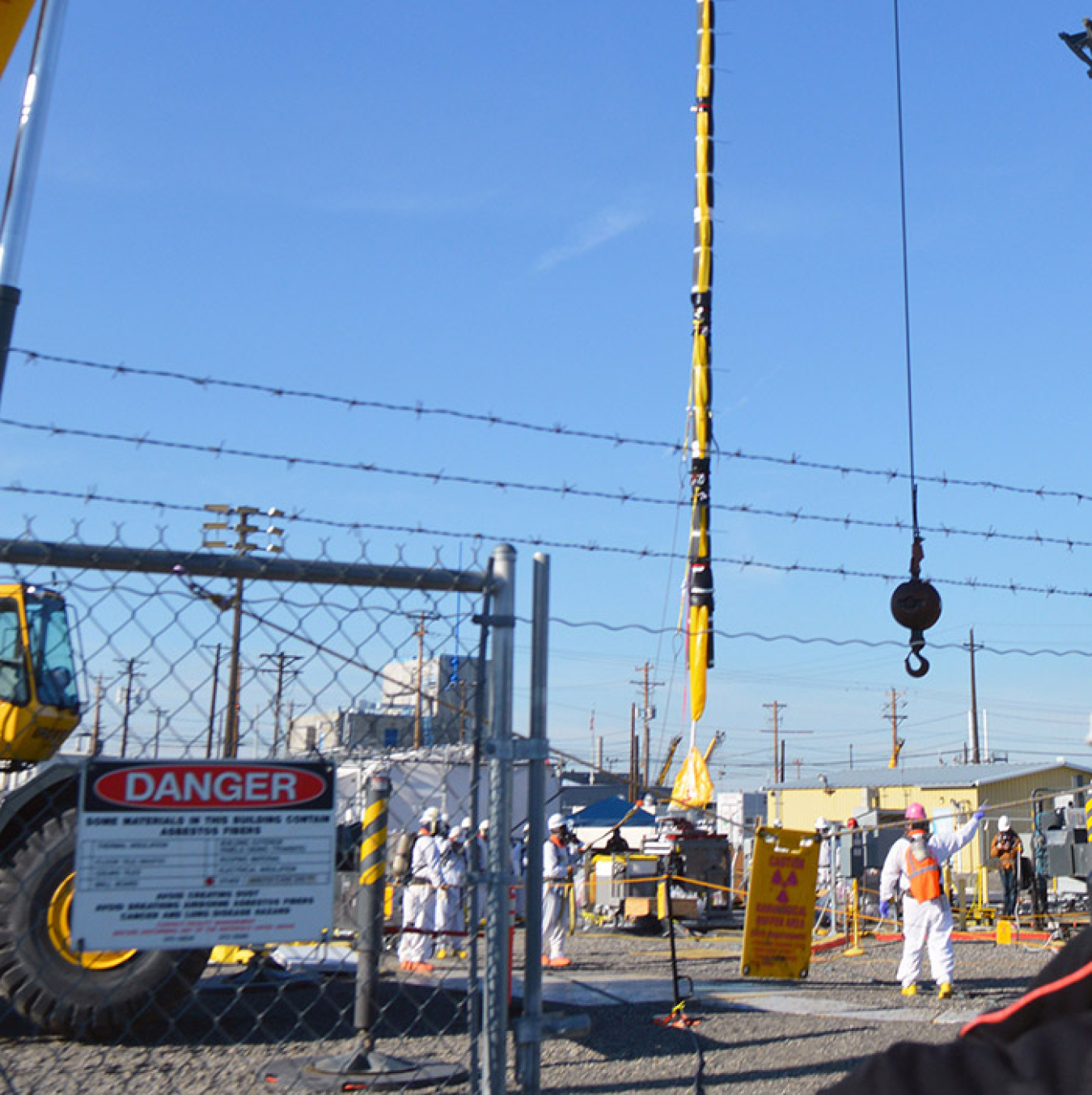 The crane that pulled the pump at the AP Farm eases it toward the disposal box.