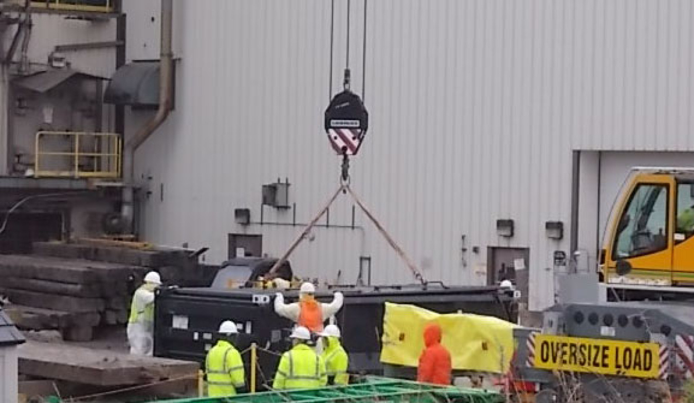 CHBWV crews use a large crane to load a section of a shield door from the site’s vitrification plant during demolition activities.