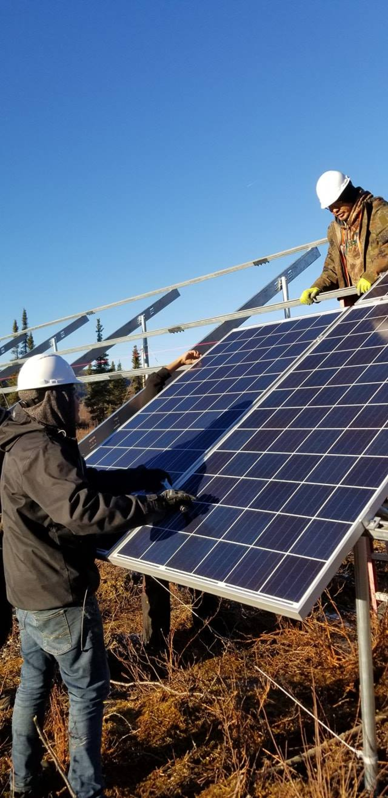 Alaska crew installing solar panels.
