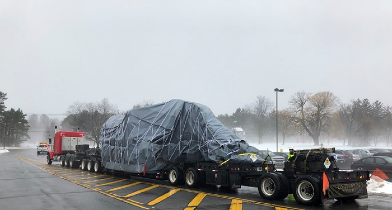 A truck ships the last excavator used in cleanup at the Separations Process Research Unit on Jan. 24.