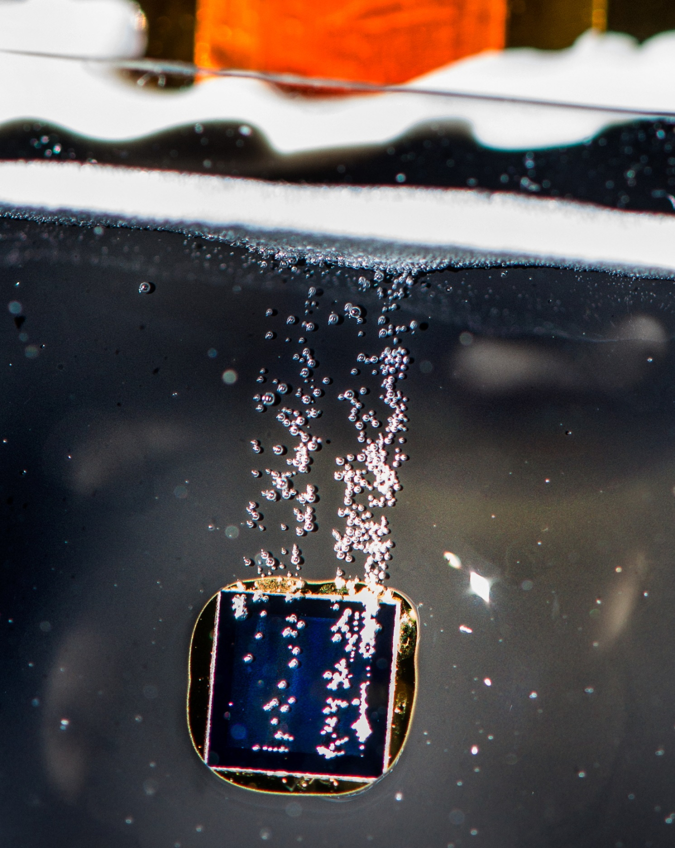 Hydrogen bubbles coming off a photelectrode immersed in electrolyte solution