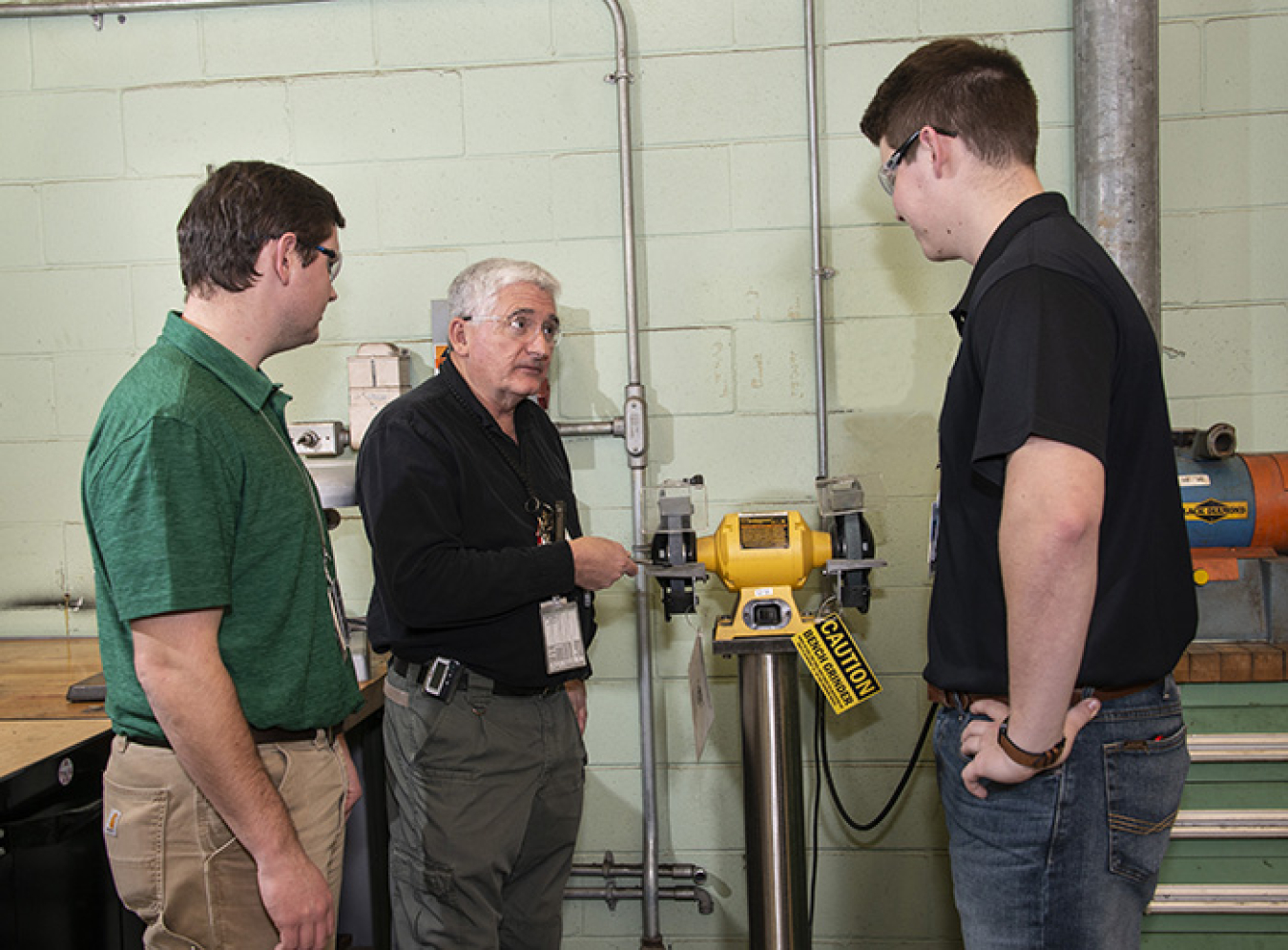 Savannah River Nuclear Solutions (SRNS) engineer Wim Lewis discusses safety requirements with SRNS employees Zach Bogard, left, and Wes McGuire, who are recent graduates of Murray State University.