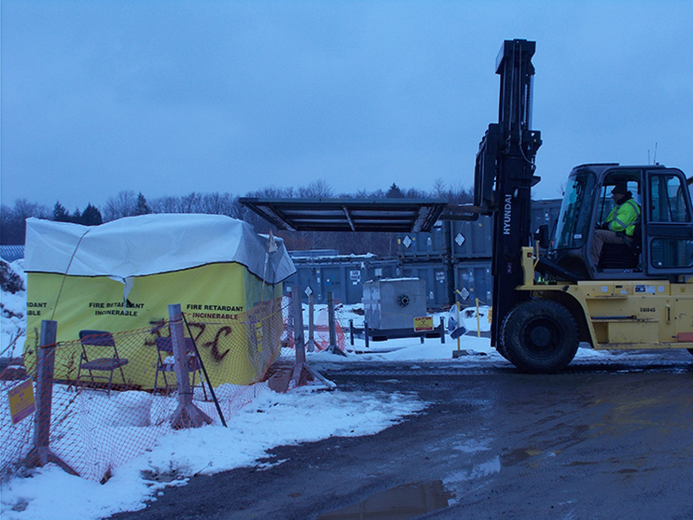 Crews at the West Valley Demonstration Project Site load and move demolition debris from the Vitrification Facility demolition work area.