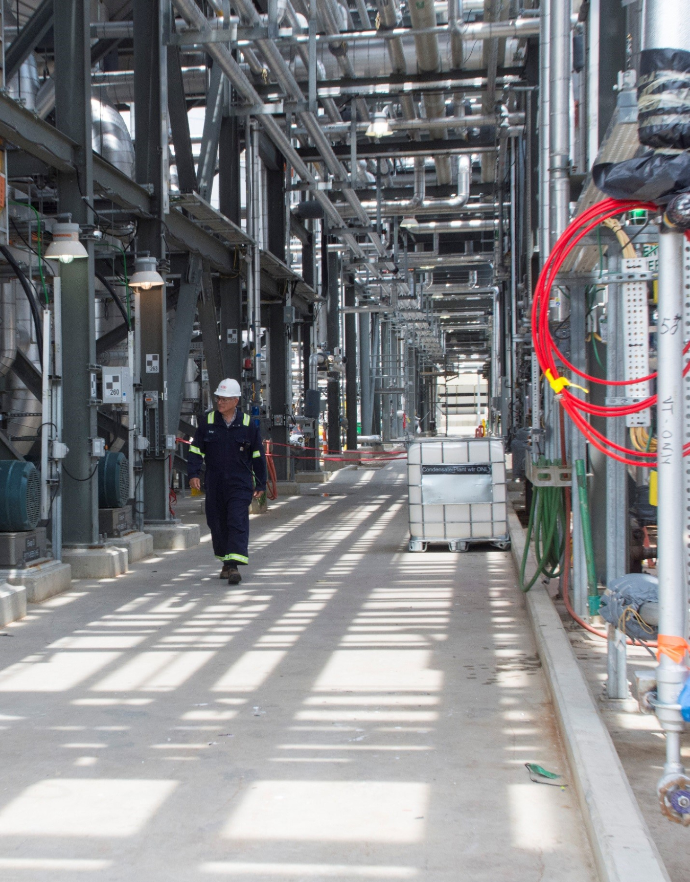 A worker walks through a bioenergy plant. 