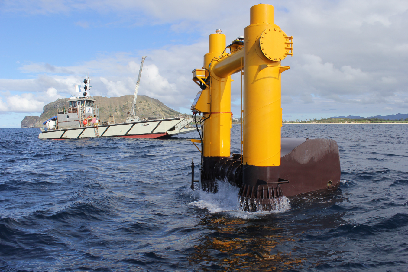 Boat in the water next to a hydrokinetic system.