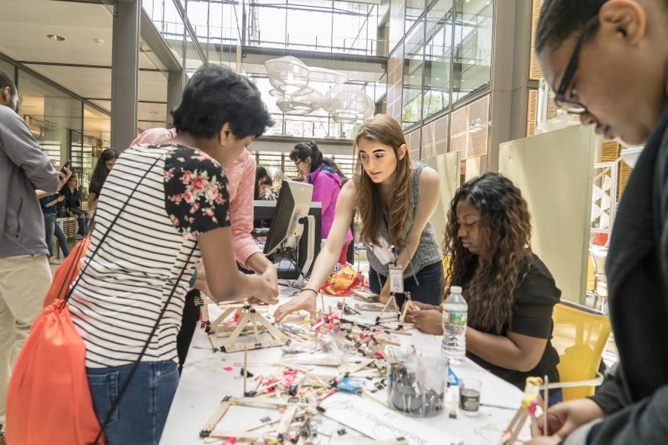 PPPL volunteers work with the students to build bridges.