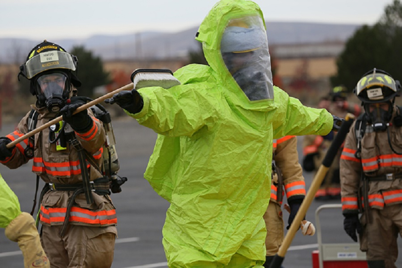 Hanford firefighter David Newman performs a mock hazardous materials decontamination on his colleague, Keith Johnson.