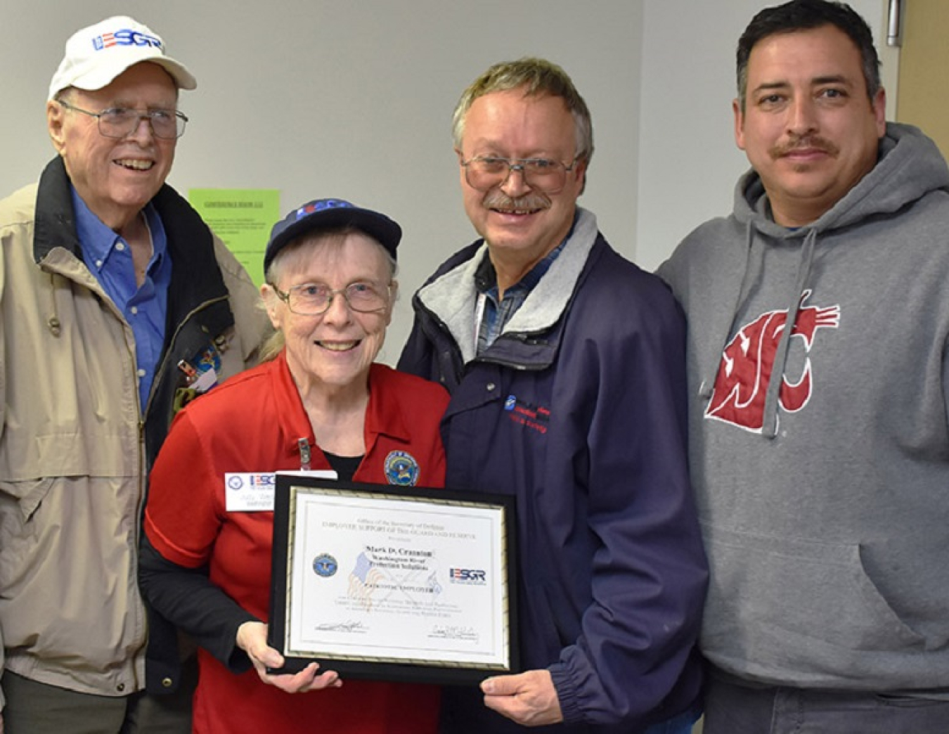 Jim Rabideau and Judy West, left, of the Employer Support of the Guard and Reserve program, present the Patriot Award to Mark Cranston, an industrial hygiene supervisor for Washington River Protection Solutions (WRPS) at the Hanford Site. 