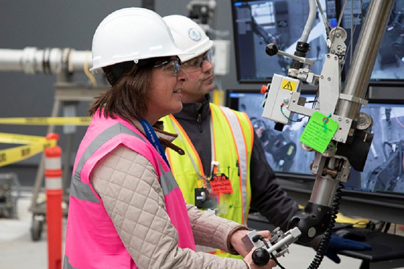 EM Assistant Secretary Anne White takes a hands-on approach at the 324 Building mock-up with assistance from operating engineer Warren Baze during her recent tour of the Hanford Site.