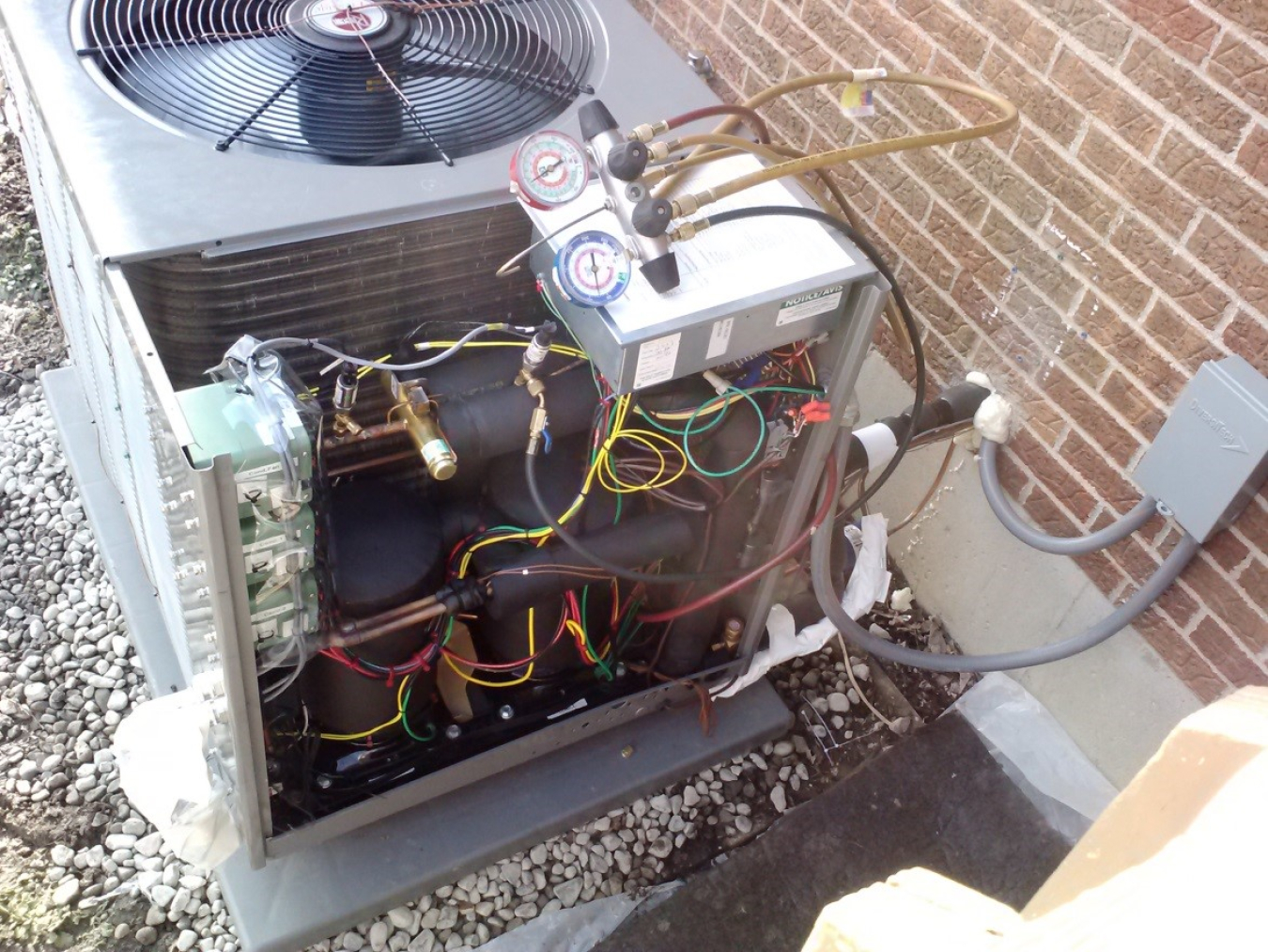 Air-source cold climate heat pump using two parallel (tandem) compressors, optimized for heating operation, with one sized for building cooling load and two sized for heating load.