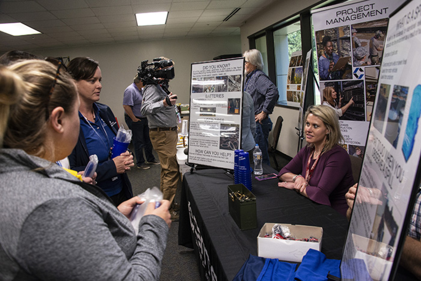 Katherine Brown, Centerra-SRS environmental protection specialist, at right, shares information about sanitary waste recycling with Savannah River Site Earth Day Celebration attendees on April 22.