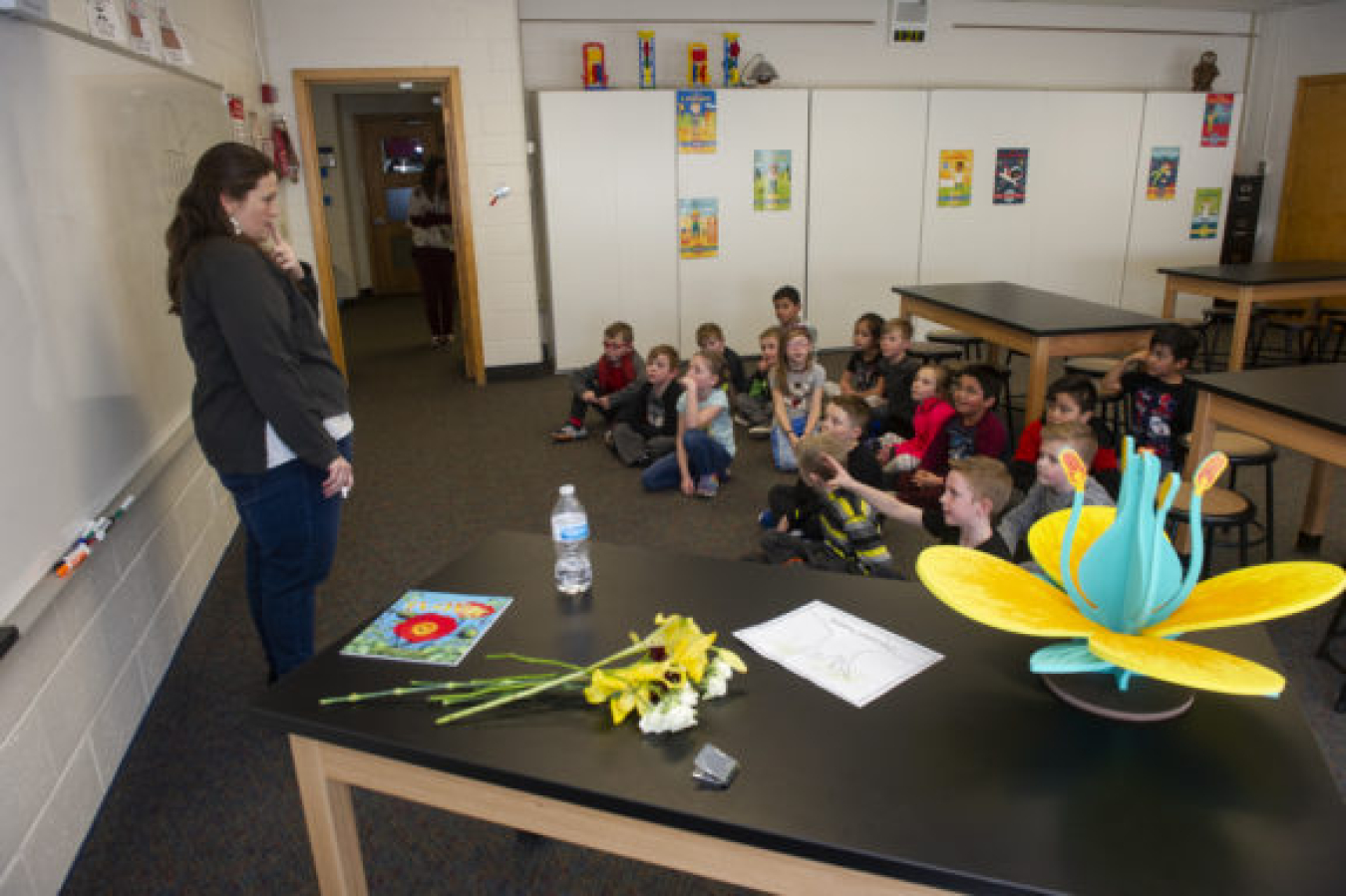 Runcorn’s second grade class gathers to name the parts of a flower.
