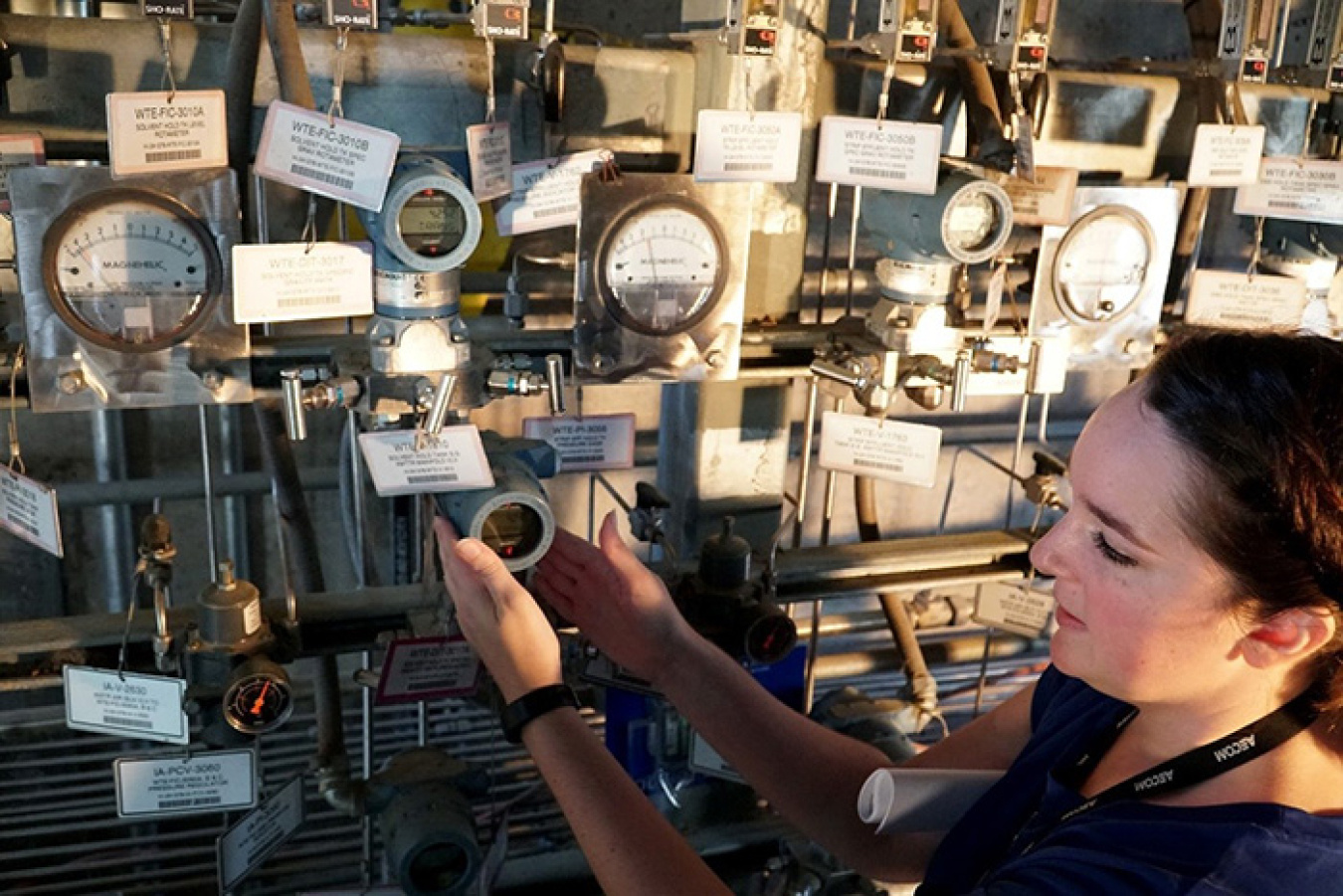 Christina Santos works on the Modular Caustic Side Solvent Extraction Unit’s instrumentation wall.