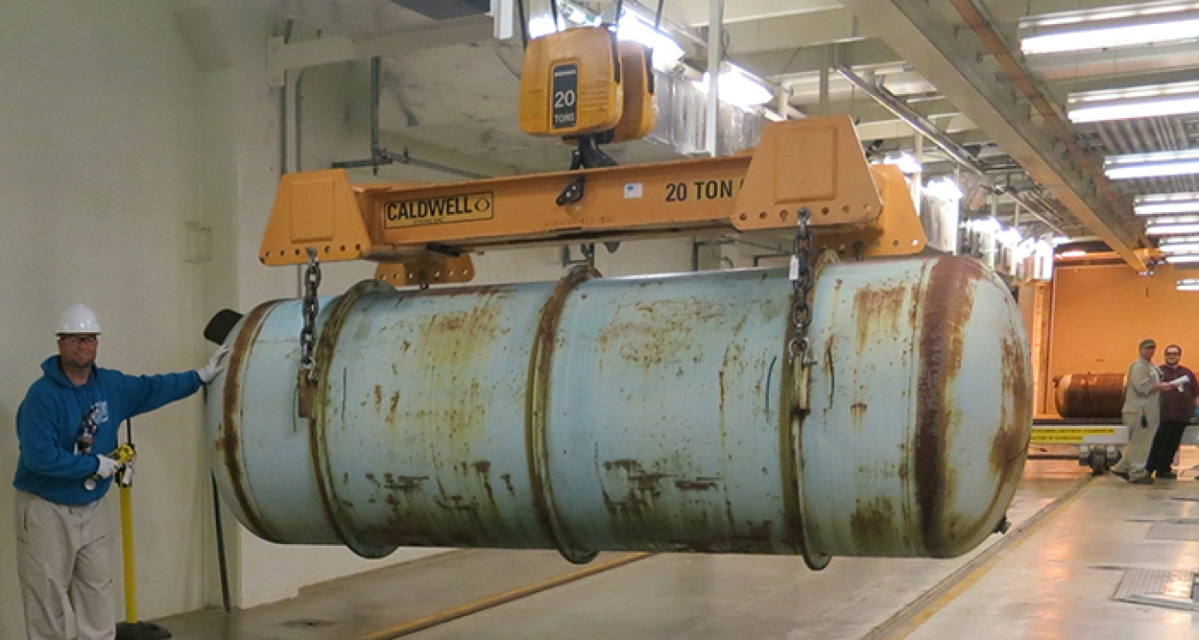 Nathan Maynard, an operations technician with Mid-America Conversion Services, moves the Depleted Uranium Hexafluoride (DUF6) storage cylinder at the Portsmouth DUF6 conversion facility.