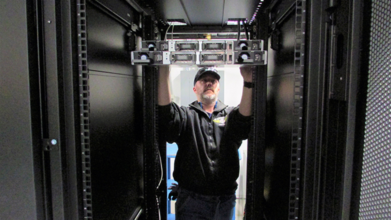 Workstation maintenance technician Joe Jensen with EM contractor Mission Support Alliance (MSA) installs equipment in a new Hanford Site data center.