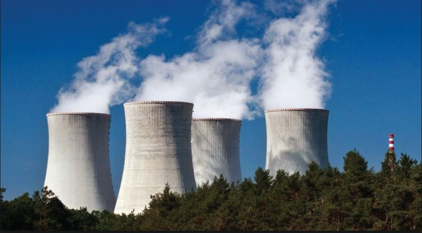 Steam emerges from three powerplant stacks. 