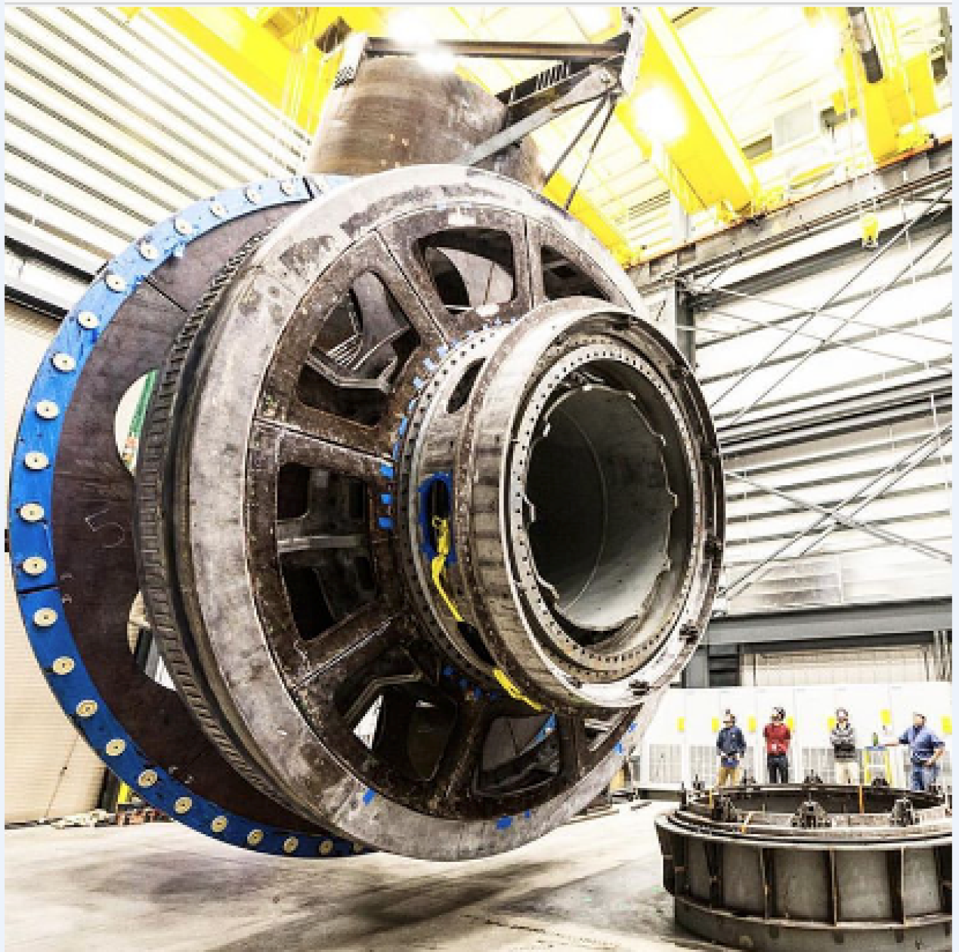 A device suspeded from the ground at a warehouse that converts energy from waves, tides and currents into electricity.