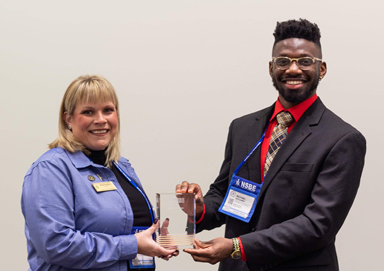 Michael Benjamin, a Washington River Protection Solutions chemical engineer at the Hanford Site, is recognized with an award at the 45th National Society of Black Engineers convention by Mikala Windham, chair of the society’s local chapter.