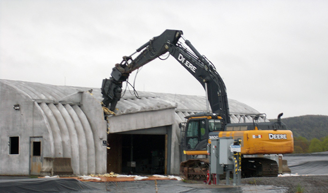 Demolition equipment takes the first bite out of a facility housing a liquid pretreatment system at EM's West Valley Demonstration Project.