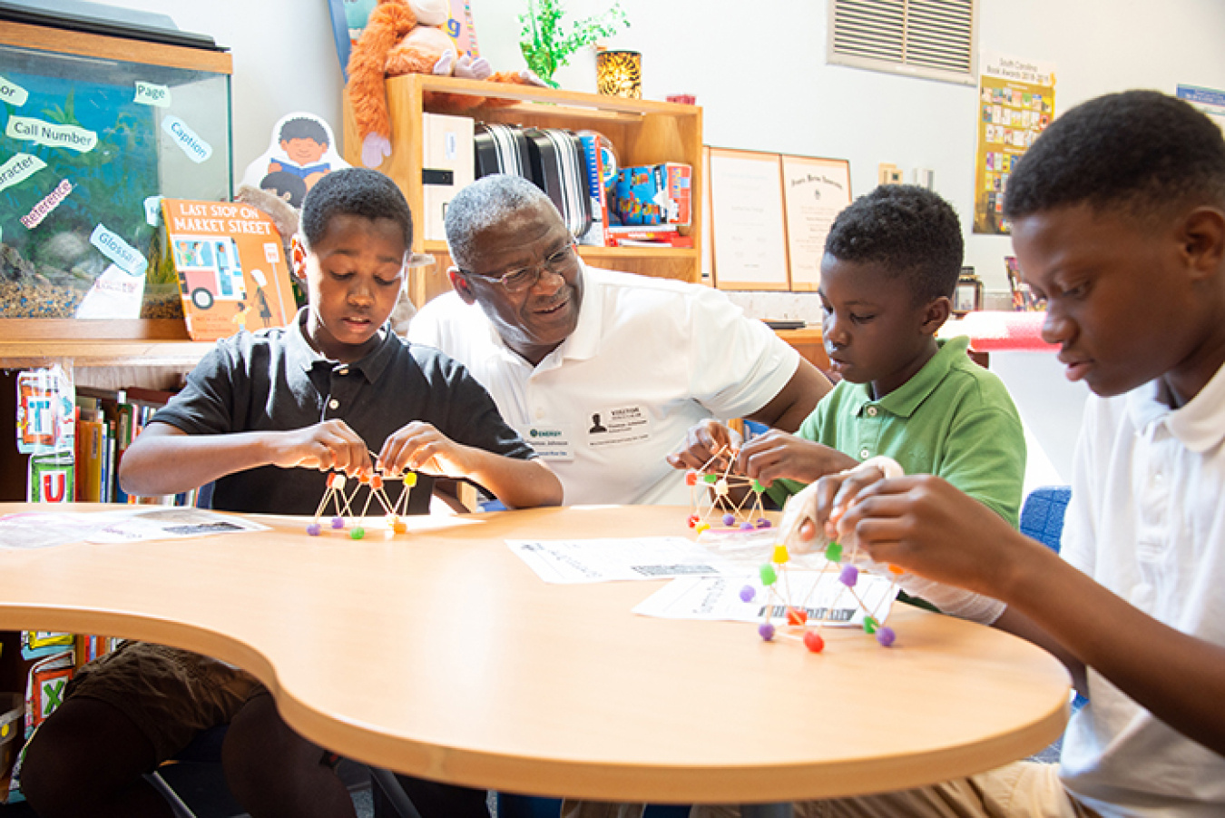 Thomas Johnson, deputy manager of DOE-Savannah River, helps a fourth-grade class at Mary Ford Elementary School create geometric domes out of gum drops.