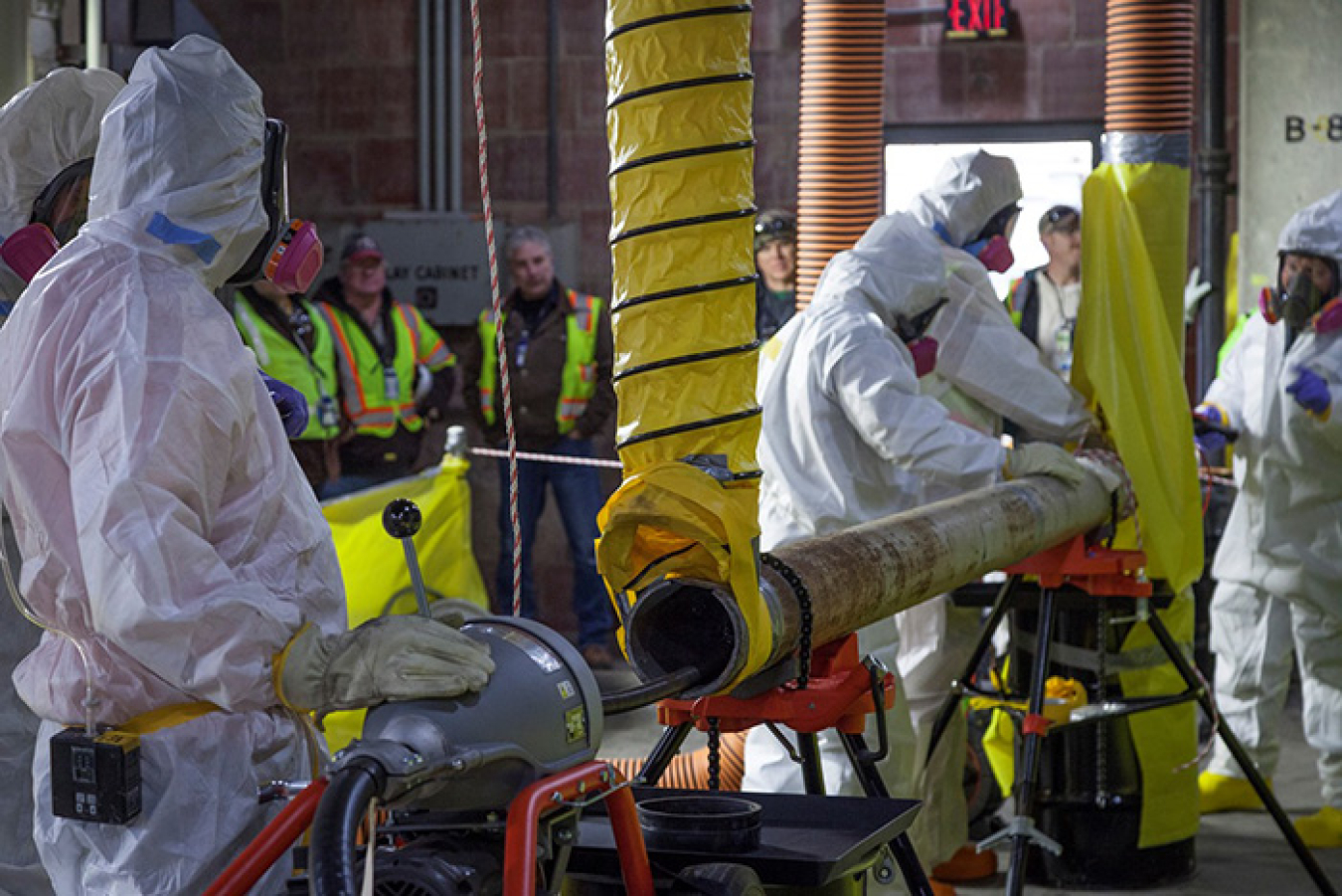 A crew tests a rotary machine with different attachments to remove crust and scale from the inside of the pipes of the Column Exchange equipment.