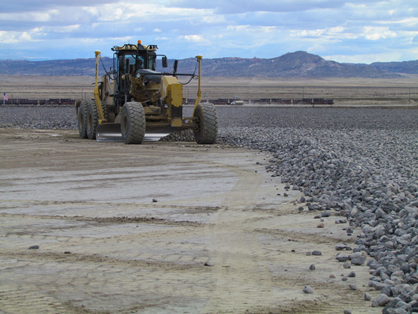 A worker places rock cover at EM’s waste disposal cell in Crescent Junction, Utah. The Moab Uranium Mill Tailings Remedial Action Project is considering transitioning to an evapotranspiration cover to improve performance and reduce costs.